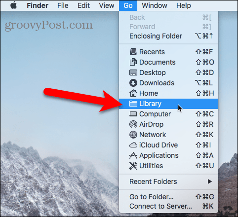 Accesați folderul Library folosind meniul Go din Finder pe Mac